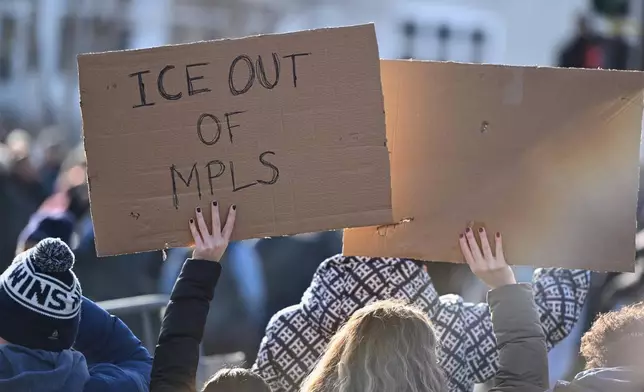 Protesters gather near the scene of the fatal shooting involving federal law enforcement agents, Wednesday, Jan. 7, 2026, in Minneapolis. (AP Photo/Tom Baker)