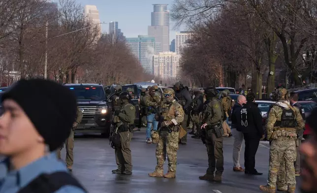 Law enforcement agents stand on the scene of a shooting in Minneapolis, on Wednesday, Jan. 7, 2026. (Alex Kormann/Star Tribune via AP)