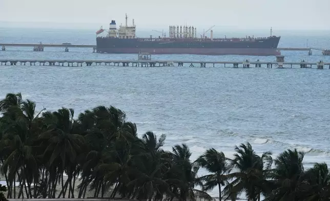 Evana, an oil tanker, is docked at El Palito port in Puerto Cabello, Venezuela, Sunday, Dec. 21, 2025. (AP Photo/Matias Delacroix)