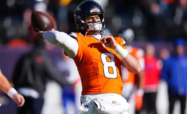 Denver Broncos quarterback Jarrett Stidham warms up before an NFL divisional round playoff football game against the Buffalo Bills, Saturday, Jan. 17, 2026, in Denver. (AP Photo/Jack Dempsey)