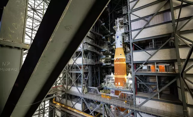 NASA's Artemis II SLS (Space Launch System) rocket and Orion spacecraft, secured to the mobile launcher, is seen inside the Vehicle Assembly building as preparations continue for roll out to Launch Pad 39B, Thursday, Jan. 15, 2026, at NASA's Kennedy Space Center in Florida. (Keegan Barber/NASA via AP)