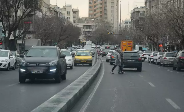 Vehicles drive on a street in downtown Tehran, Iran, Thursday, Jan. 15, 2026. (AP Photo/Vahid Salemi)