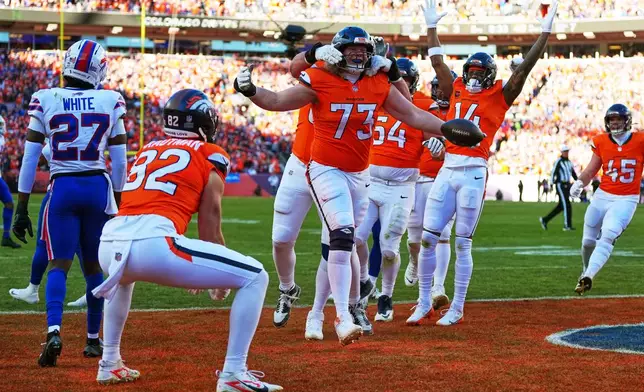 Denver Broncos offensive tackle Frank Crum (73) celebrates with teammates after a touchdown during the first half of an NFL divisional round playoff football game against the Buffalo Bills, Saturday, Jan. 17, 2026, in Pittsburgh. (AP Photo/Jack Dempsey)