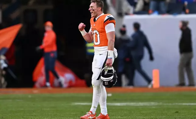 Denver Broncos quarterback Bo Nix (10) celebrates during the first half of an NFL divisional round playoff football game against the Buffalo Bills, Saturday, Jan. 17, 2026, in Denver. (AP Photo/RJ Sangosti)