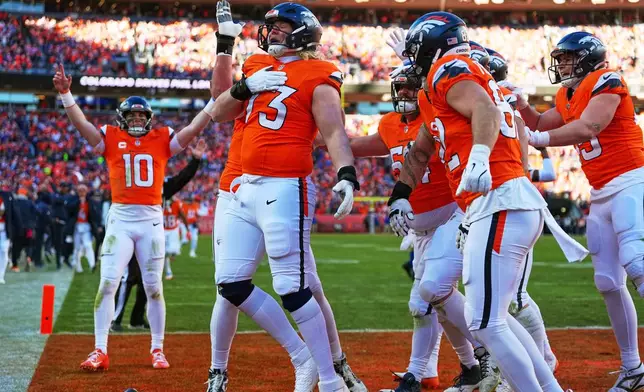 Denver Broncos offensive tackle Frank Crum (73) celebrates with teammates after a touchdown during the first half of an NFL divisional round playoff football game against the Buffalo Bills, Saturday, Jan. 17, 2026, in Pittsburgh. (AP Photo/Jack Dempsey)