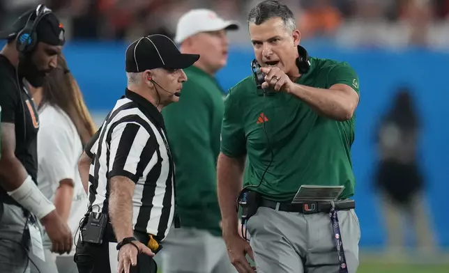 Miami head coach Mario Cristobal yells from the sideline during the second half of the Fiesta Bowl NCAA college football playoff semifinal game against Mississippi, Thursday, Jan. 8, 2026, in Glendale, Ariz. (AP Photo/Rick Scuteri)