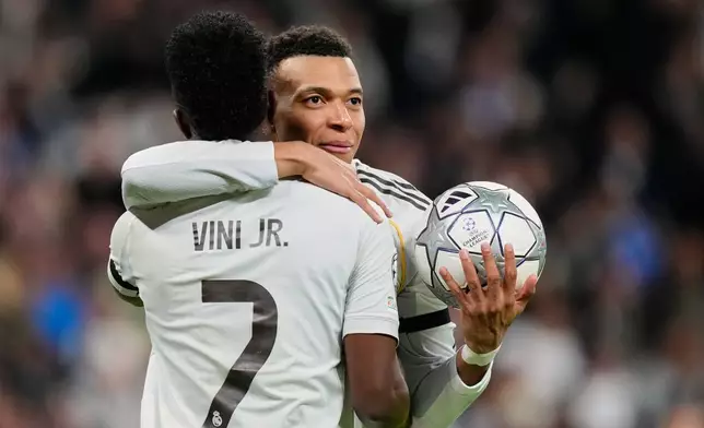 Real Madrid's Kylian Mbappe celebrates with Vinicius Junior his side's second goal during the Champions League opening phase soccer match between Real Madrid and Monaco in Madrid on Tuesday, Jan. 20, 2026. (AP Photo/Jose Breton)