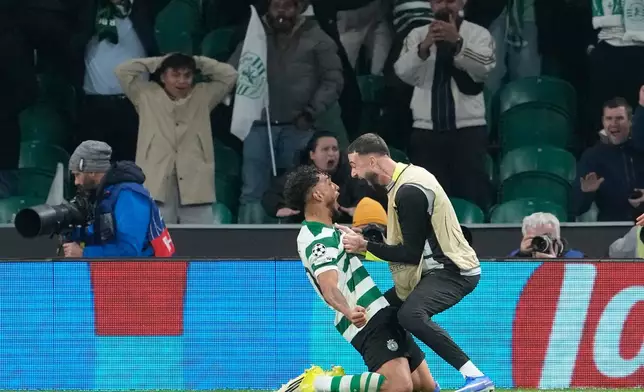 Sporting's Luis Suarez, left, celebrates after scoring his side's second goal during the Champions League opening phase soccer match between Sporting CP and Paris Saint-Germain, in Lisbon, Tuesday, Jan. 20, 2026. (AP Photo/Armando Franca)
