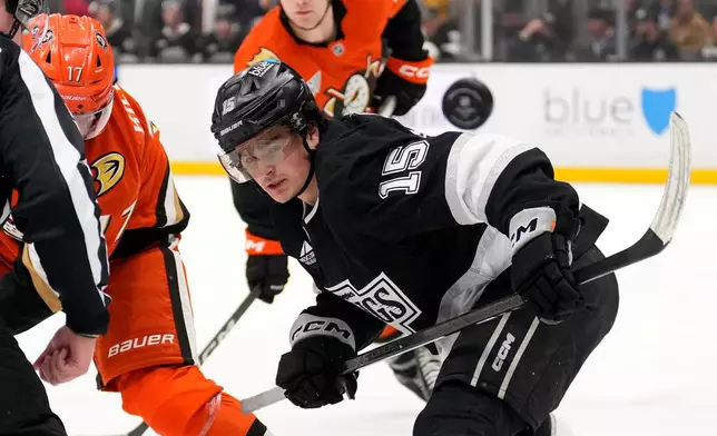 Los Angeles Kings center Alex Turcotte, right, watches the puck fly away during a face off with Anaheim Ducks left wing Alex Killorn, left, during the first period of an NHL hockey game Friday, Jan. 16, 2026, in Los Angeles. (AP Photo/Mark J. Terrill)