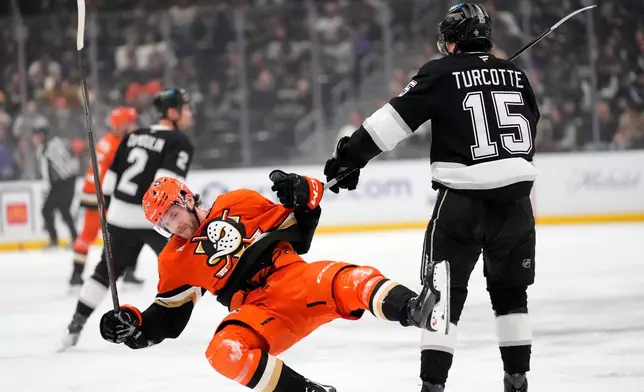 Anaheim Ducks center Jansen Harkins, left, is shoved to the ice by Los Angeles Kings center Alex Turcotte during the first period of an NHL hockey game Friday, Jan. 16, 2026, in Los Angeles. (AP Photo/Mark J. Terrill)