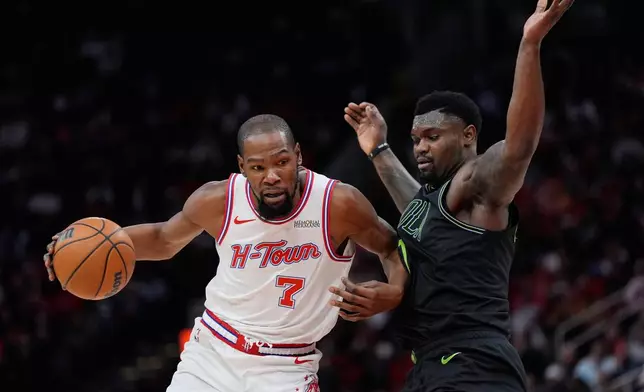 Houston Rockets forward Kevin Durant (7) controls the ball against New Orleans Pelicans forward Zion Williamson (1) during the second half of an NBA basketball game in Houston, Sunday, Jan. 18, 2026. (AP Photo/Ashley Landis)