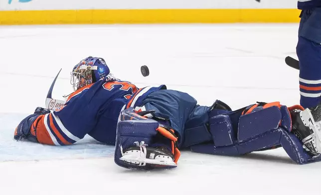 Edmonton Oilers goalie Tristan Jarry makes a save during first-period NHL hockey game action against the Anaheim Ducks in Edmonton, Alberta, Monday, Jan. 26, 2026. (Jason Franson/The Canadian Press via AP)