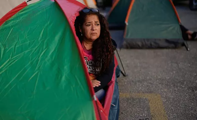 Maria Soledad Osorio, whose son Simon Chacon is detained at a different facility, camps outside the Zona 7 detention center of the Bolivarian National Police in solidarity with the relatives of other detainees in Caracas, Venezuela, Tuesday, Jan. 20, 2026. (AP Photo/Ariana Cubillos)