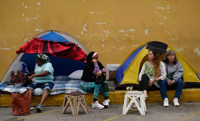 Relatives wait outside Zone 7 of the Bolivarian National Police station for news of loved ones they say were detained and have not heard from in Caracas, Venezuela, Monday, Jan. 19, 2026. (AP Photo/Ariana Cubillos)