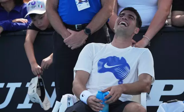 Carlos Alcaraz of Spain reacts during a practice session ahead of the Australian Open tennis championship in Melbourne, Australia, Thursday, Jan. 15, 2026. (AP Photo/Dita Alangkara)