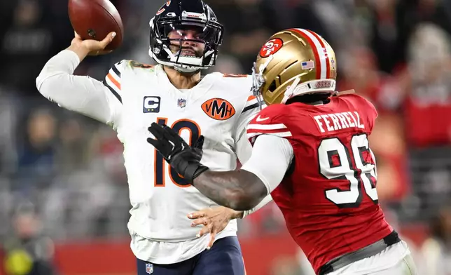 Chicago Bears quarterback Caleb Williams, left, passes while pressured by San Francisco 49ers defensive end Clelin Ferrell (96) during the second half of an NFL football game in Santa Clara, Calif., Sunday, Dec. 28, 2025. (AP Photo/Eakin Howard)
