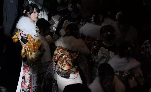 Young adults walk at a venue to celebrate the Coming-of-Age Day, a centuries-old tradition and national holiday marking the milestone from childhood to adulthood, Monday, Jan. 12, 2026, in Yokohama near Tokyo. (AP Photo/Eugene Hoshiko)