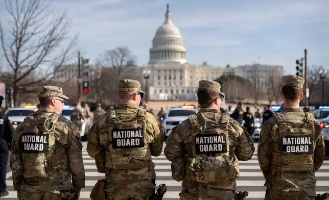 National Guard members stand before the body of Metropolitan Police Department officer Terry Bennett is driven past the Capitol, Thursday, Jan. 8, 2026, in Washington. (AP Photo/Mark Schiefelbein)