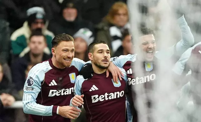 Aston Villa's Emi Buendia, center, celebrates with teammates after scoring their side's first goal during their English Premier League soccer match against Newcastle United in Newcastle upon Tyne, England, Sunday, Jan. 25, 2026. (Owen Humphreys/PA via AP)