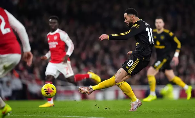 Manchester United's Matheus Cunha scores their side's third goal of the game during the English Premier League soccer match between Arsenal and Manchester United in London, Sunday, Jan. 25, 2026. (Mike Egerton/PA via AP)