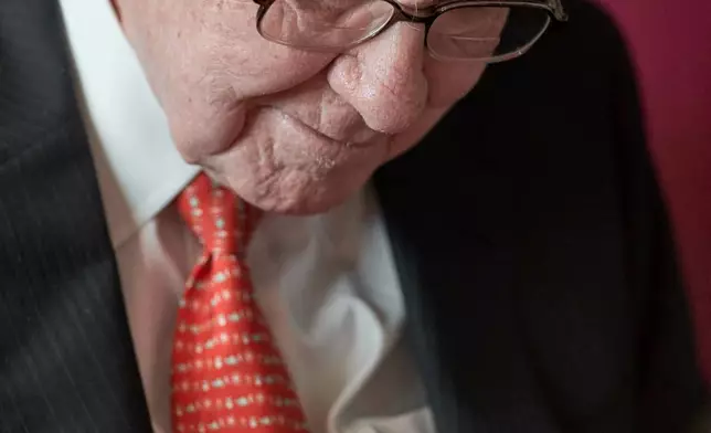 FILE - Warren Buffett, Chairman and CEO of Berkshire Hathaway, puts pen to paper during a game of bridge following the annual Berkshire Hathaway shareholders meeting in Omaha, Neb., Sunday, May 5, 2019. (AP Photo/Nati Harnik, File)