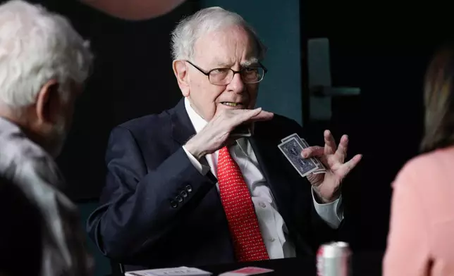 FILE - Warren Buffett, chairman and CEO of Berkshire Hathaway, gestures as he plays bridge outside Berkshire-owned Borsheims jewelry store in Omaha, Neb., Sunday, May 6, 2018. (AP Photo/Nati Harnik, File)