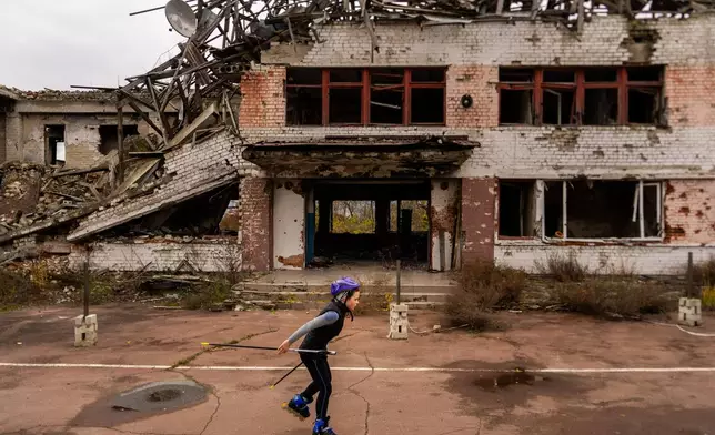 A young biathlete trains outside the destroyed ski base in Chernihiv, Ukraine, Thursday, Oct. 30, 2025. (AP Photo/Julia Demaree Nikhinson)