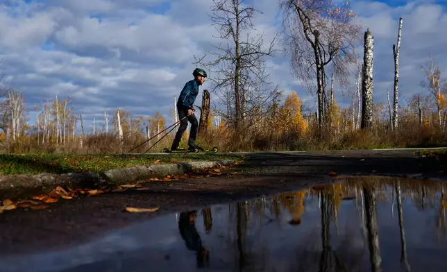 A biathlete trains at the ski base in Chernihiv, Ukraine, Thursday, Oct. 30, 2025. (AP Photo/Julia Demaree Nikhinson)