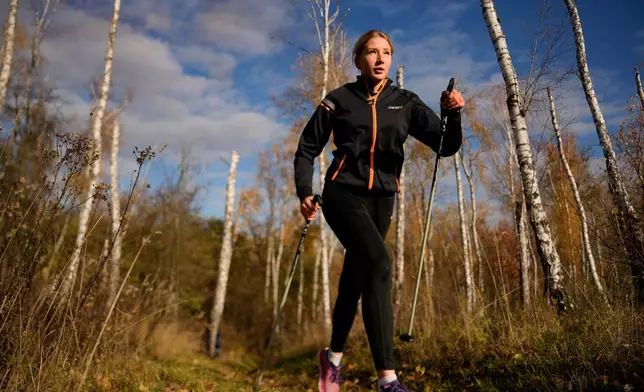 Biathlete Yekateryna Mashtalier, 18, runs during a training session at the ski base in Chernihiv, Ukraine, Thursday, Oct. 30, 2025. (AP Photo/Julia Demaree Nikhinson)