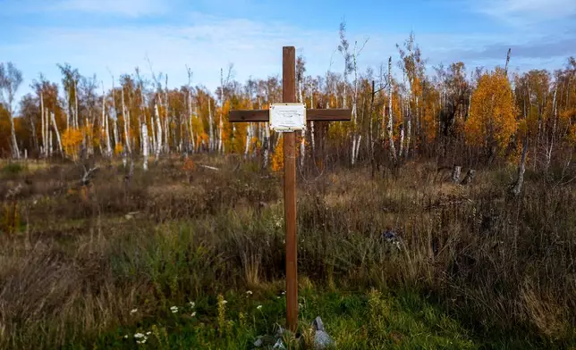 A cross memorialises Ukrainian defenders outside the destroyed ski base in Chernihiv, Ukraine, Thursday, Oct. 30, 2025. (AP Photo/Julia Demaree Nikhinson)