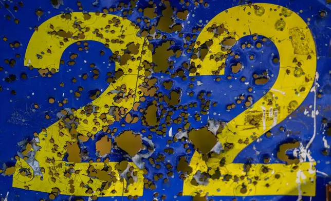 A steel shooting target is peppered with gunshot holes at the ski base in Chernihiv, Ukraine, Thursday, Oct. 30, 2025. (AP Photo/Julia Demaree Nikhinson)