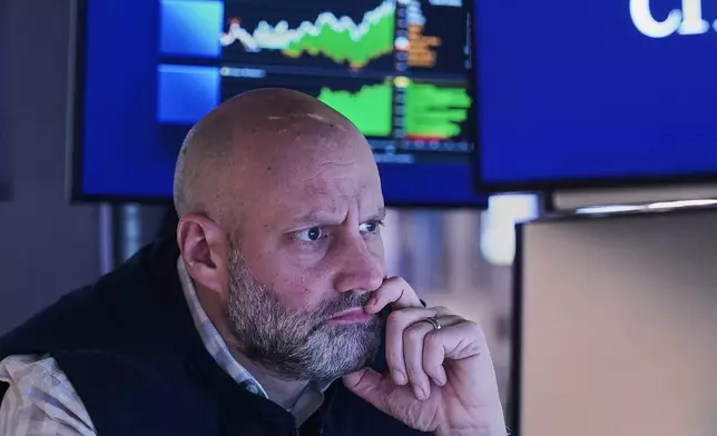 Specialist Meric Greenbaum works at his post on the floor of the New York Stock Exchange, Monday, Jan. 26, 2026. (AP Photo/Richard Drew)