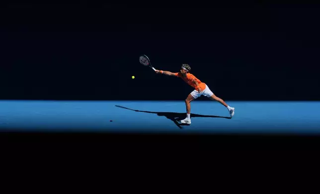 Gabriel Diallo of Canada plays a forehand return to Alexander Zverev of Germany during their first round match at the Australian Open tennis championship in Melbourne, Australia, Sunday, Jan. 18, 2026. (AP Photo/Dita Alangkara)