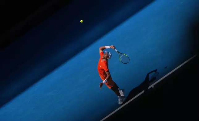 Felix Auger-Aliassime of Canada serves to Nuno Borges of Portugal during their first round match at the Australian Open tennis championship in Melbourne, Australia, Monday, Jan. 19, 2026. (AP Photo/Asanka Brendon Ratnayake)