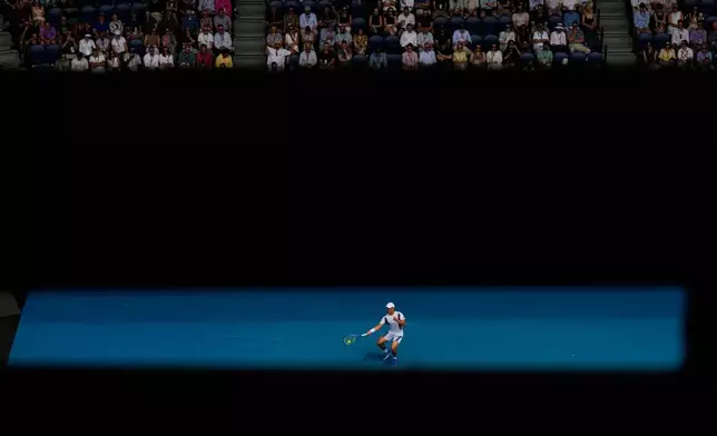 Mackenzie McDonald of the U.S. plays a forehand return to Alex de Minaur of Australia during their first round match at the Australian Open tennis championship in Melbourne, Australia, Monday, Jan. 19, 2026. (AP Photo/Aaron Favila)