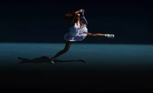 Coco Gauff of the U.S. plays a forehand return to Karolina Muchova of the Czech Republic during their fourth round match at the Australian Open tennis championship in Melbourne, Australia, Sunday, Jan. 25, 2026. (AP Photo/Asanka Brendon Ratnayake)