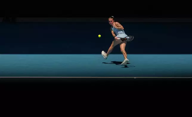 Oleksandra Oliynykova of Ukraine plays a forehand return to Madison Keys of the U.S. during their first round match at the Australian Open tennis championship in Melbourne, Australia, Tuesday, Jan. 20, 2026. (AP Photo/Asanka Brendon Ratnayake)