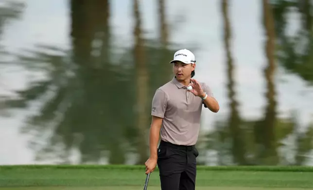 Min Woo Lee, of Austalia, waves to the crowd after making par at the 9th hole during the first round of the American Express golf event at the Jack Nicklaus Tournament Course at PGA West Thursday, Jan. 22, 2026, in La Quinta, Calif. (AP Photo/Ross D. Franklin)