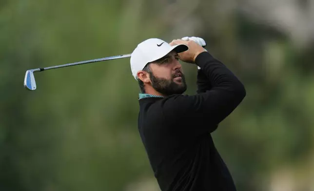 Scottie Scheffler watches his shot from the third tee during the first round of the American Express golf event at La Quinta County Club Thursday, Jan. 22, 2026, in La Quinta, Calif. (AP Photo/Ross D. Franklin)