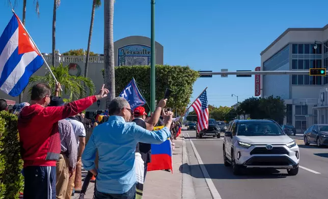 People celebrate outside Versailles Cuban Cuisine after President Donald Trump announced Venezuelan President Nicolás Maduro had been captured and flown out of the country, in Miami, Saturday, Jan. 3, 2026. (AP Photo/Jen Golbeck)