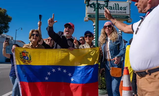 People celebrate outside Versailles Cuban Cuisine after President Donald Trump announced Venezuelan President Nicolás Maduro had been captured and flown out of the country, in Miami, Saturday, Jan. 3, 2026. (AP Photo/Jen Golbeck)