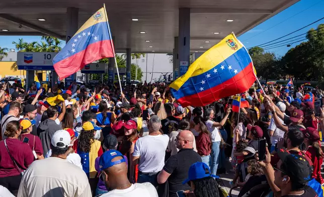 People celebrate after President Donald Trump announced Venezuelan President Nicolás Maduro had been captured and flown out of the country, in Doral, Fla., Saturday, Jan. 3, 2026. (AP Photo/Jen Golbeck)