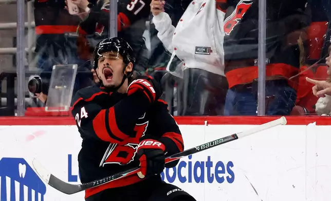 Carolina Hurricanes' Seth Jarvis (24) celebrates after his goal against the Buffalo Sabres during the third period of an NHL hockey game in Raleigh, N.C., Monday, Jan. 19, 2026. (AP Photo/Karl DeBlaker)
