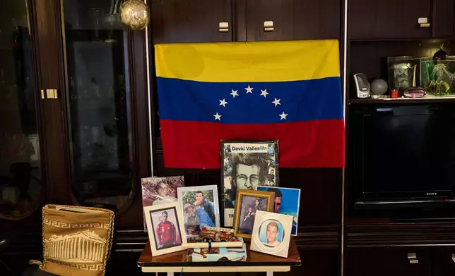 Pictures of the late David José Vallenilla Luis are placed in the living room of his father, David José Vallenilla, in Madrid, Tuesday, Jan. 13, 2026. (AP Photo/Bernat Armangue)