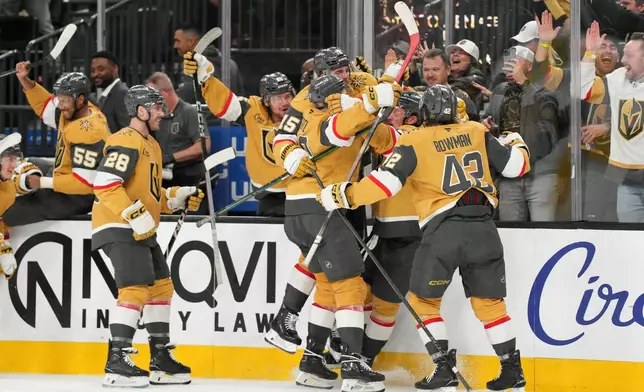 Vegas Golden Knights center Jack Eichel (9) and teammates celebrate his goal against the Toronto Maple Leafs during overtime of an NHL hockey game Thursday, Jan. 15, 2026, in Las Vegas. (AP Photo/Candice Ward)