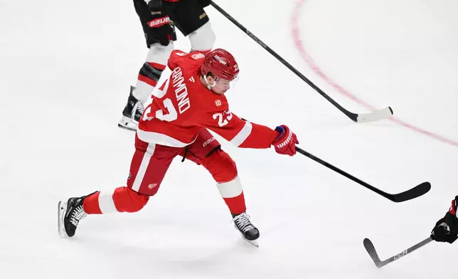 Detroit Red Wings left wing Lucas Raymond (23) shoots and scores a goal against the Ottawa Senators in the second period of an NHL hockey game, Sunday, Jan. 18, 2026, in Detroit. (AP Photo/Lon Horwedel)