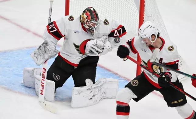 Ottawa Senators goaltender James Reimer (47) stops a shot on goal against the Detroit Red Wings in the second period of an NHL hockey game, Sunday, Jan. 18, 2026, in Detroit. (AP Photo/Lon Horwedel)