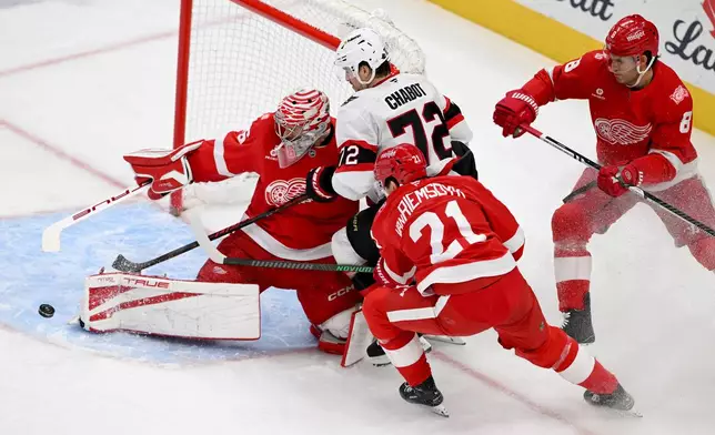 Ottawa Senators defenseman Thomas Chabot (72) tries to score on Detroit Red Wings goaltender John Gibson (36) after skating past Detroit Red Wings left wing James van Riemsdyk (21) in the first period of an NHL hockey game, Sunday, Jan. 18, 2026, in Detroit. (AP Photo/Lon Horwedel)