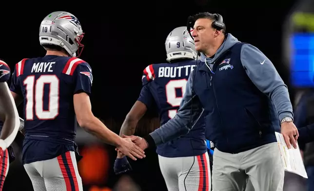 New England Patriots head coach Mike Vrabel, right, greets quarterback Drake Maye during the second half of an NFL football game against the Miami Dolphins in Foxborough, Mass., Sunday, Jan. 4, 2026. (AP Photo/Charles Krupa)