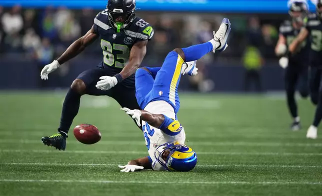 Los Angeles Rams wide receiver Xavier Smith (19) fumbles during a punt return and Seattle Seahawks' Dareke Young (83) recovers the ball during the second half of the NFC Championship NFL football game Sunday, Jan. 25, 2026, in Seattle. (AP Photo/Lindsey Wasson)